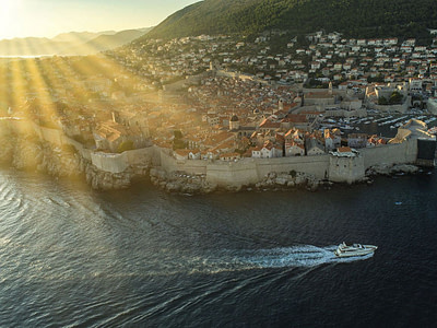 Salt yacht driving by the city walls of dubrovnik, croatia