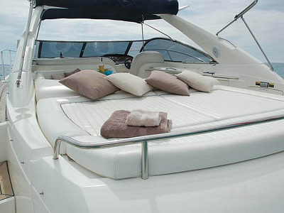 sundeck with a pile of cousins and towels on the yacht sunseeker 50, which can be rented in Dubrovnik, Croatia