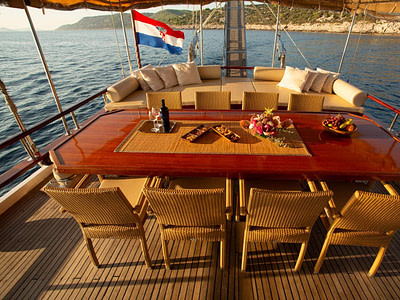 Outdoor table, chairs and lounge sofas onboard Gulet
