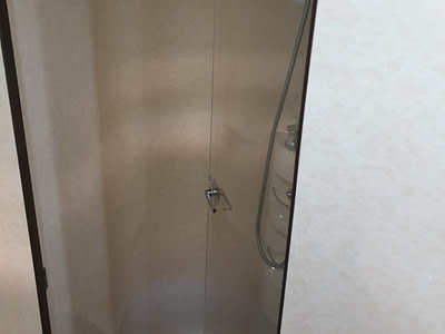Indoor shower in a Ferretti 591 yacht