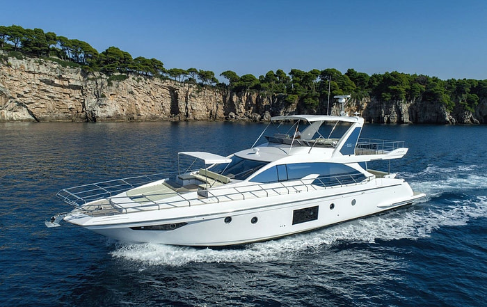 Side view of the Azimut luxury yacht cruising in front of Kolocep island