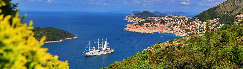 Photograph of a sail ship and Dubrovnik